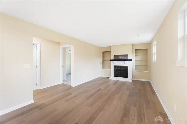 unfurnished living room with wood-type flooring