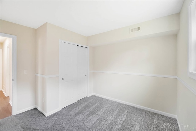 unfurnished bedroom with carpet and a closet