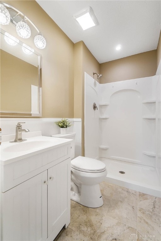 bathroom with vanity, toilet, and walk in shower