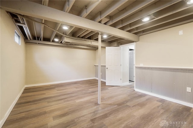 basement with hardwood / wood-style floors