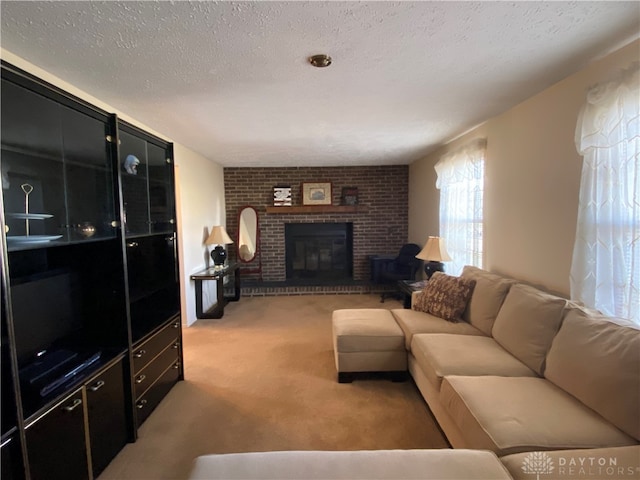 carpeted living room featuring a fireplace and a textured ceiling