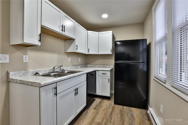 kitchen with black appliances, white cabinetry, sink, and a wealth of natural light