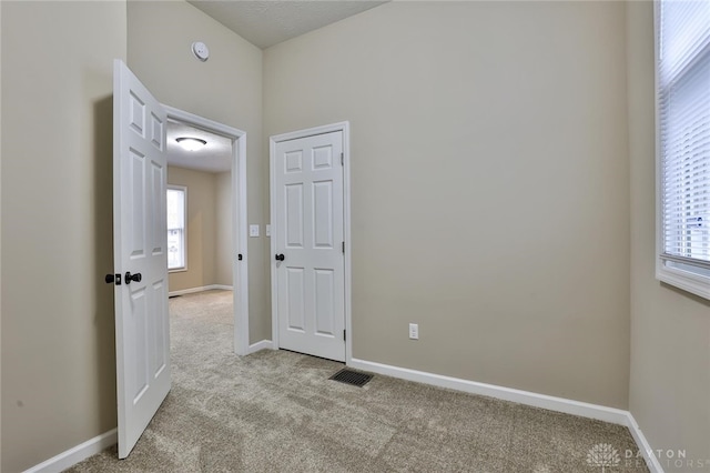 spare room with light colored carpet