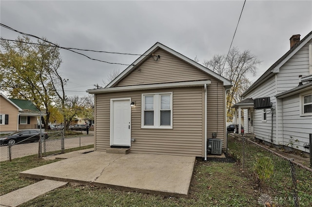 rear view of property featuring cooling unit and a patio area