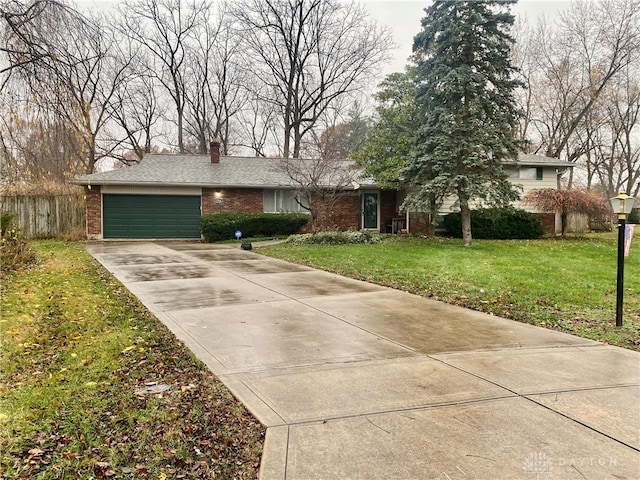 single story home with a garage and a front lawn