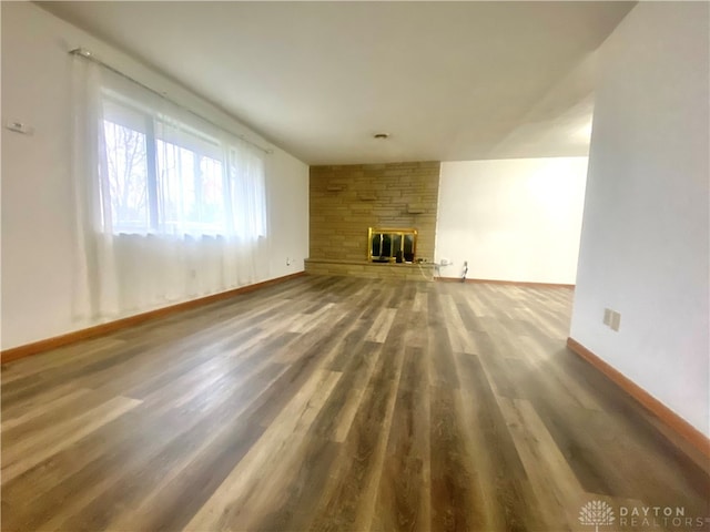 unfurnished living room featuring hardwood / wood-style flooring and a fireplace