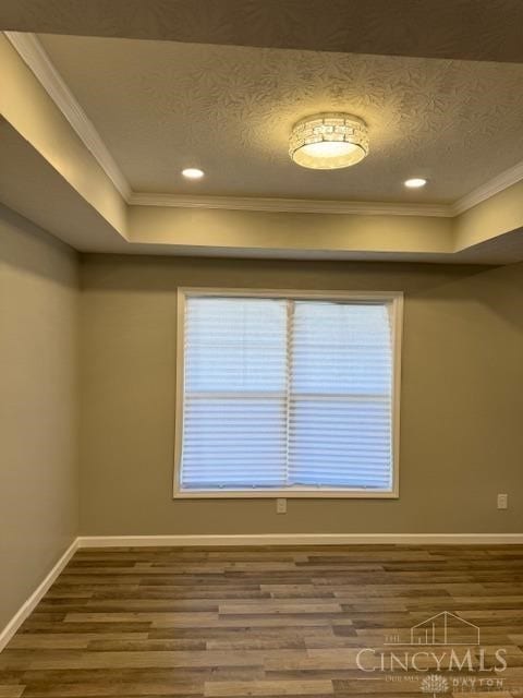 spare room featuring hardwood / wood-style floors and ornamental molding