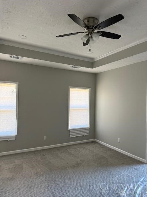 empty room featuring carpet flooring, a textured ceiling, ceiling fan, and crown molding