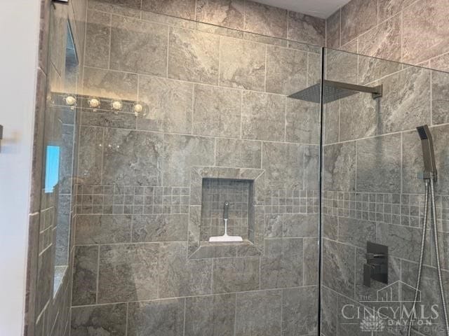 bathroom with a tile shower