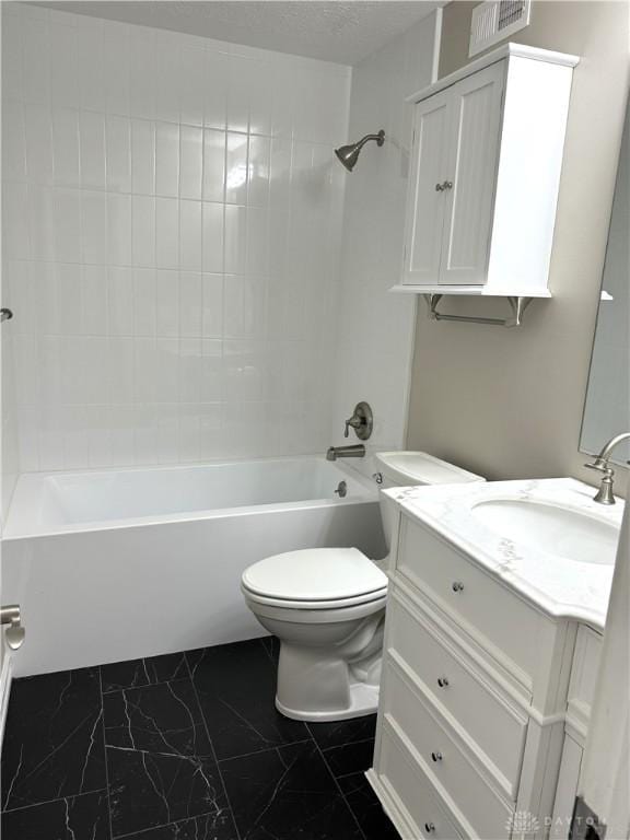 full bathroom with vanity, toilet, and tiled shower / bath