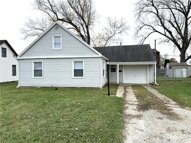 view of front of property featuring a garage and a front lawn