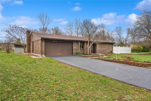 single story home with a garage and a front lawn