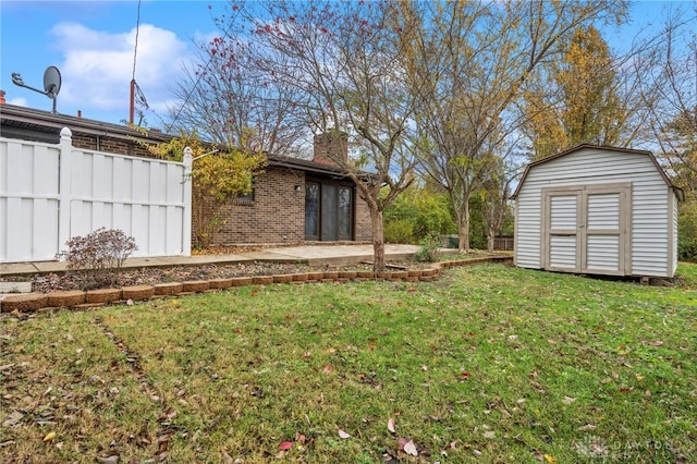 view of yard featuring a patio and a storage unit