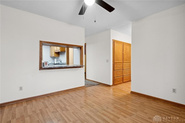 unfurnished room featuring light wood-type flooring and ceiling fan