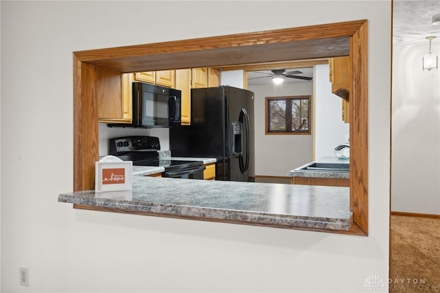 kitchen featuring ceiling fan, sink, carpet, and black appliances