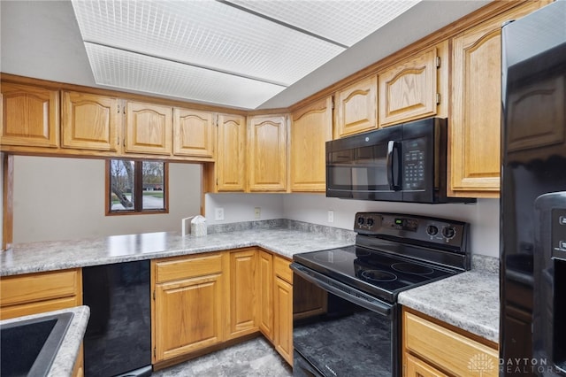 kitchen featuring kitchen peninsula and black appliances