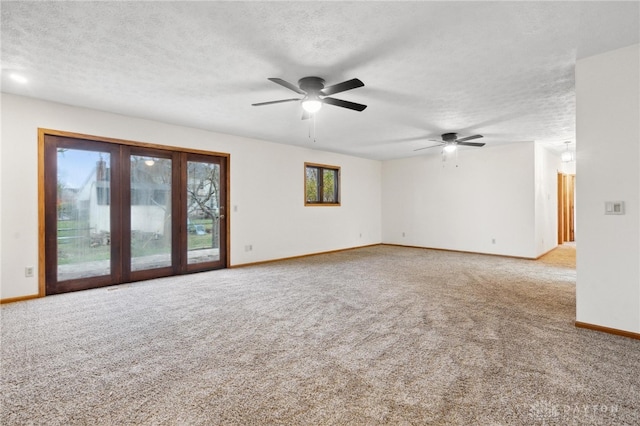 carpeted spare room with ceiling fan and a textured ceiling