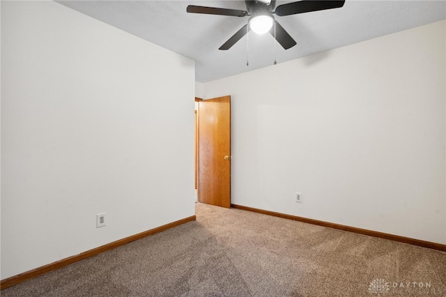 empty room with ceiling fan and carpet floors