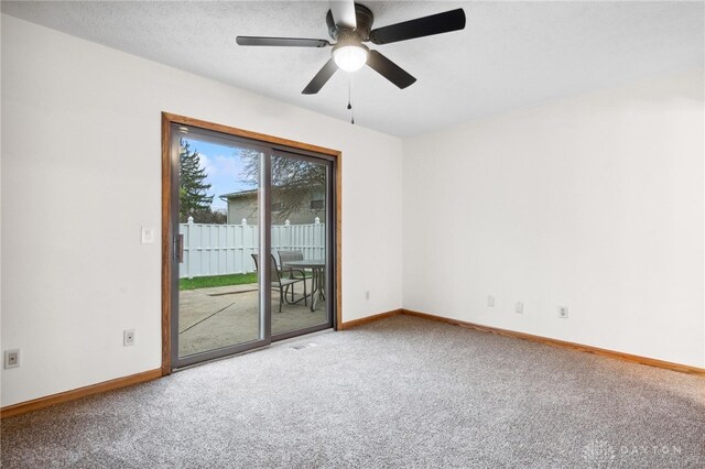 empty room featuring carpet flooring, ceiling fan, and a textured ceiling