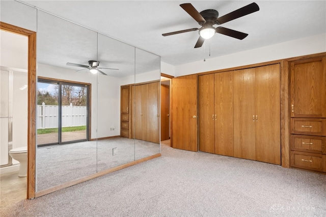 unfurnished bedroom with access to outside, connected bathroom, ceiling fan, and light colored carpet