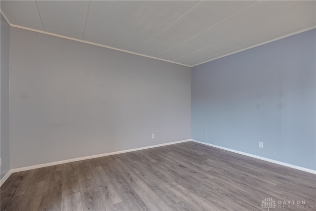 empty room featuring light wood-type flooring and crown molding