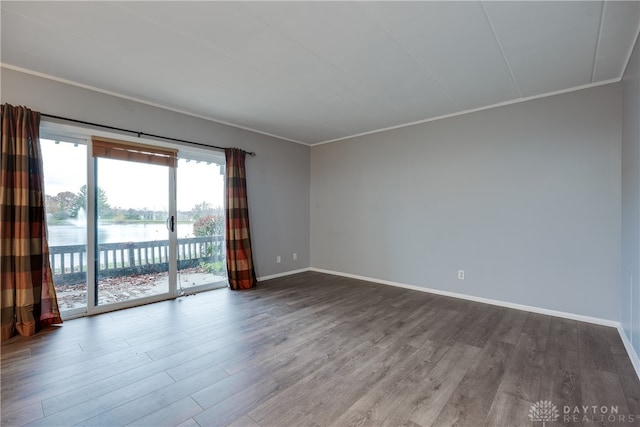 unfurnished room with hardwood / wood-style flooring, a water view, and ornamental molding