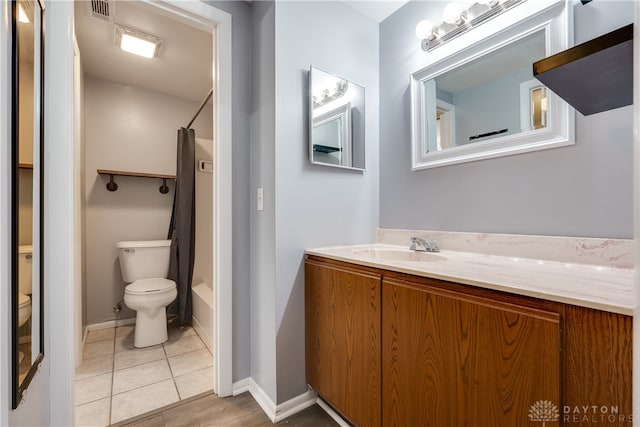 full bathroom with shower / bath combination with curtain, vanity, toilet, and tile patterned floors