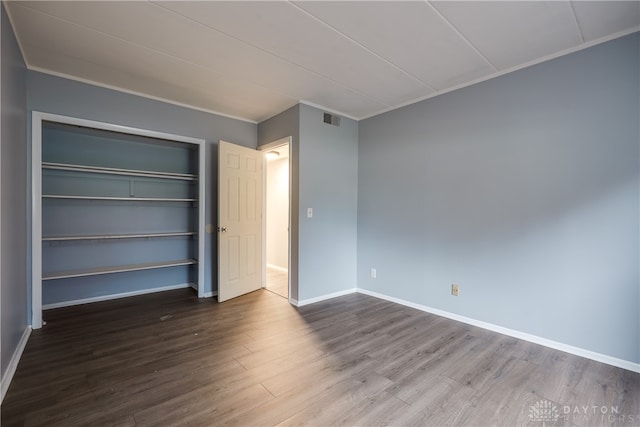 unfurnished bedroom featuring hardwood / wood-style floors and crown molding