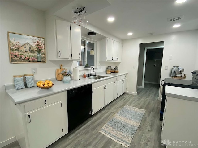 kitchen with white cabinetry, dishwasher, sink, hanging light fixtures, and light wood-type flooring