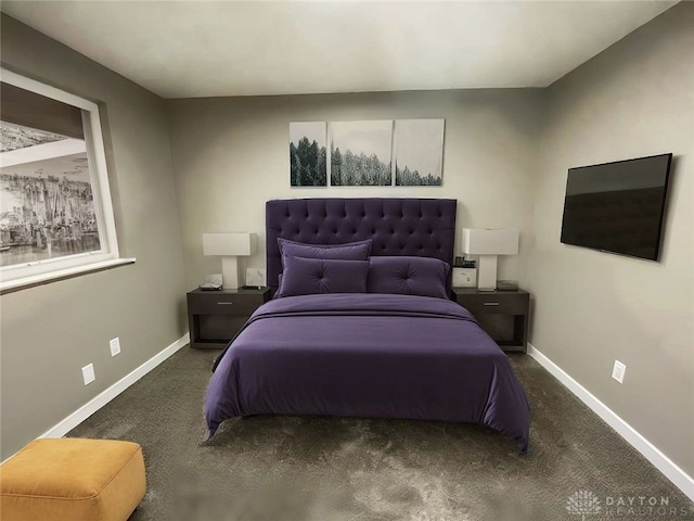 bedroom featuring dark colored carpet