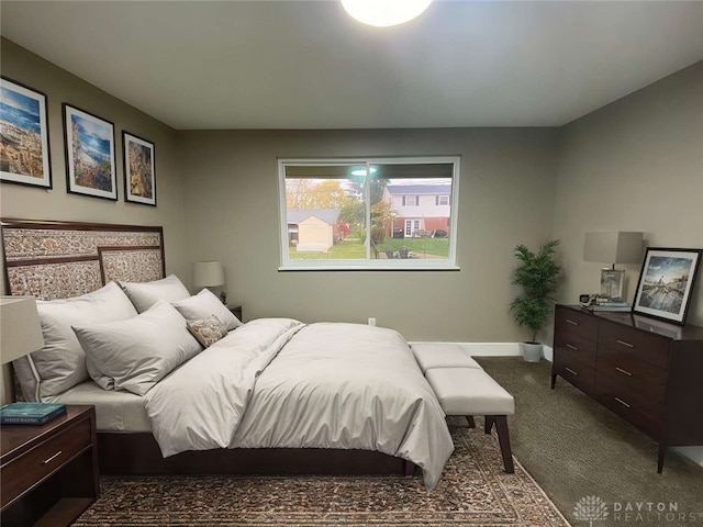 bedroom featuring dark carpet