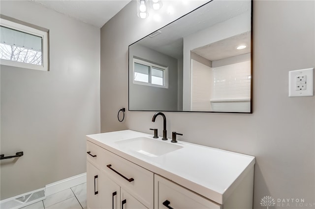 bathroom featuring tile patterned flooring, plenty of natural light, and vanity