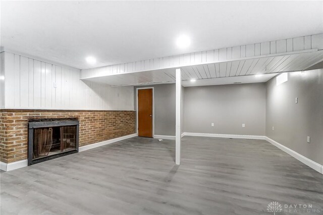 basement featuring hardwood / wood-style floors and a fireplace