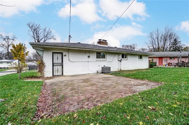 back of house featuring central AC unit, a yard, and a patio