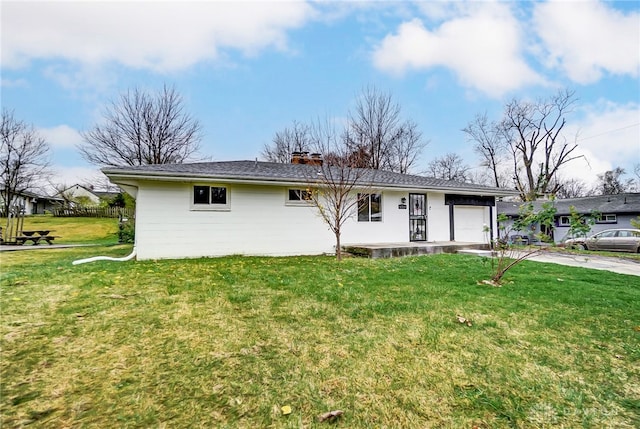 view of front of property with a front yard and a garage