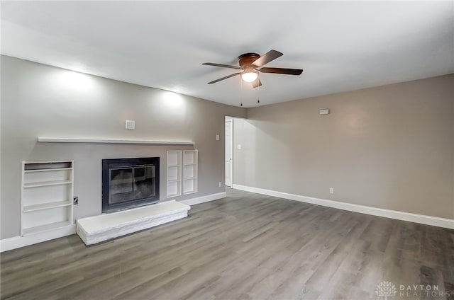 unfurnished living room featuring hardwood / wood-style flooring and ceiling fan