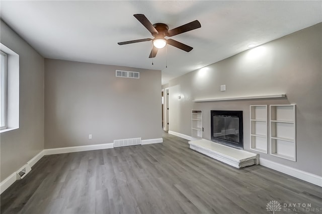 unfurnished living room featuring hardwood / wood-style flooring and ceiling fan