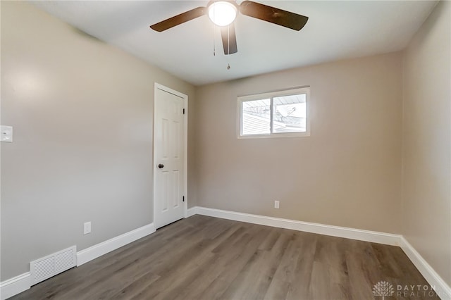 spare room featuring wood-type flooring and ceiling fan