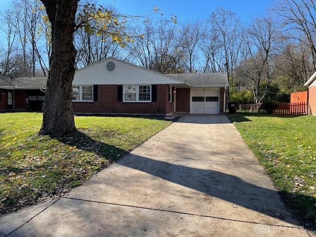 single story home featuring a front yard and a garage