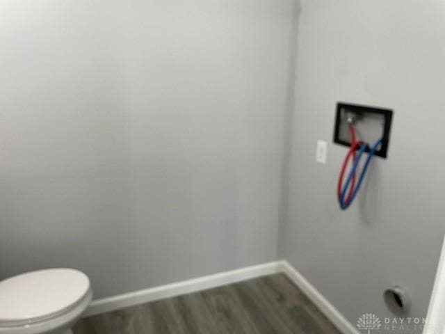 bathroom featuring wood-type flooring and toilet