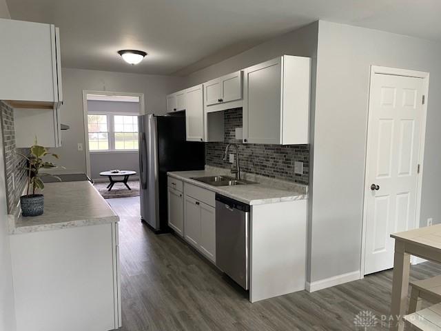 kitchen featuring sink, white cabinets, dark hardwood / wood-style floors, and appliances with stainless steel finishes