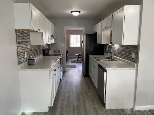 kitchen featuring dark wood-type flooring, appliances with stainless steel finishes, sink, and white cabinets