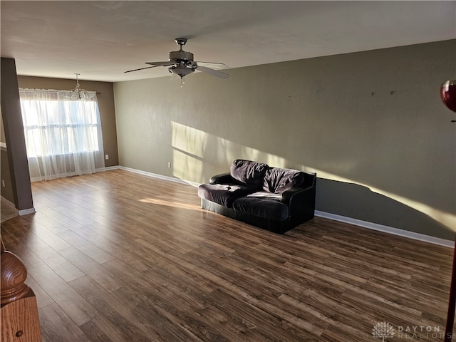 unfurnished room featuring dark wood-type flooring and ceiling fan