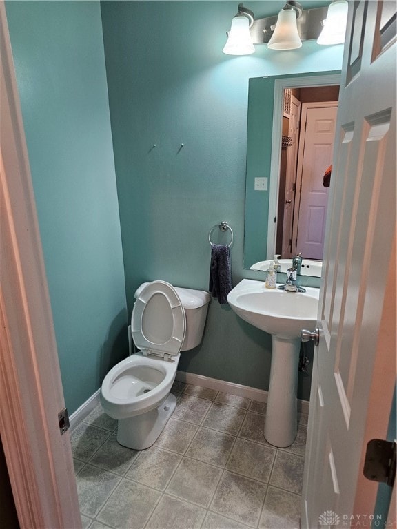 bathroom with tile patterned floors, toilet, and sink