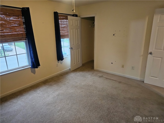 unfurnished room featuring light colored carpet