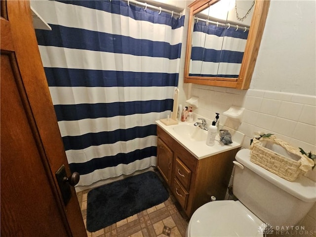 bathroom featuring tile walls, vanity, toilet, and a shower with shower curtain