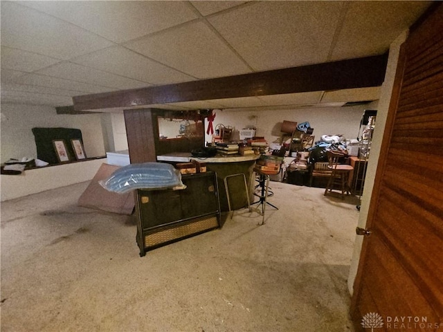 basement with a paneled ceiling