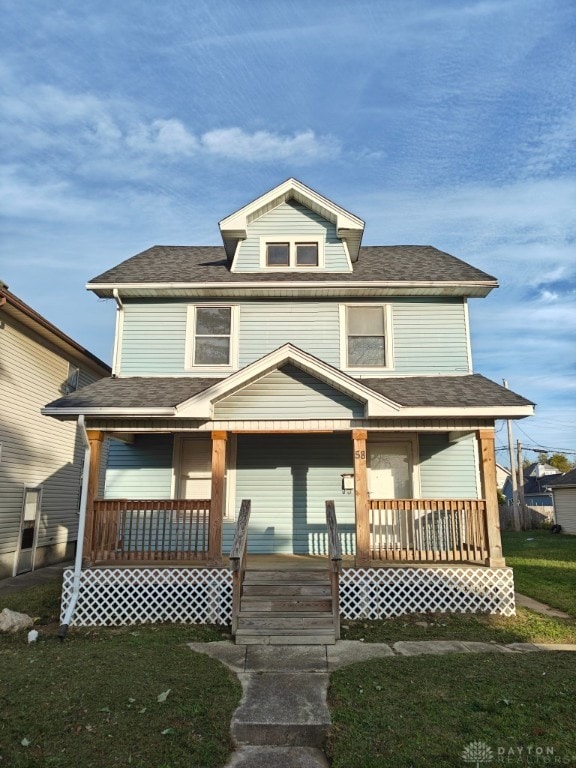 view of front of house featuring a porch and a front lawn