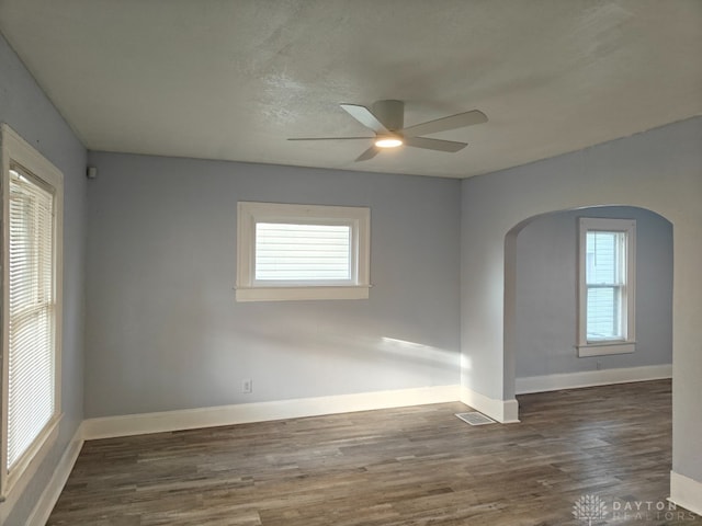 spare room with ceiling fan and dark hardwood / wood-style flooring