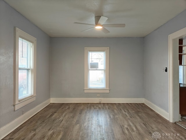 unfurnished room with ceiling fan and dark wood-type flooring